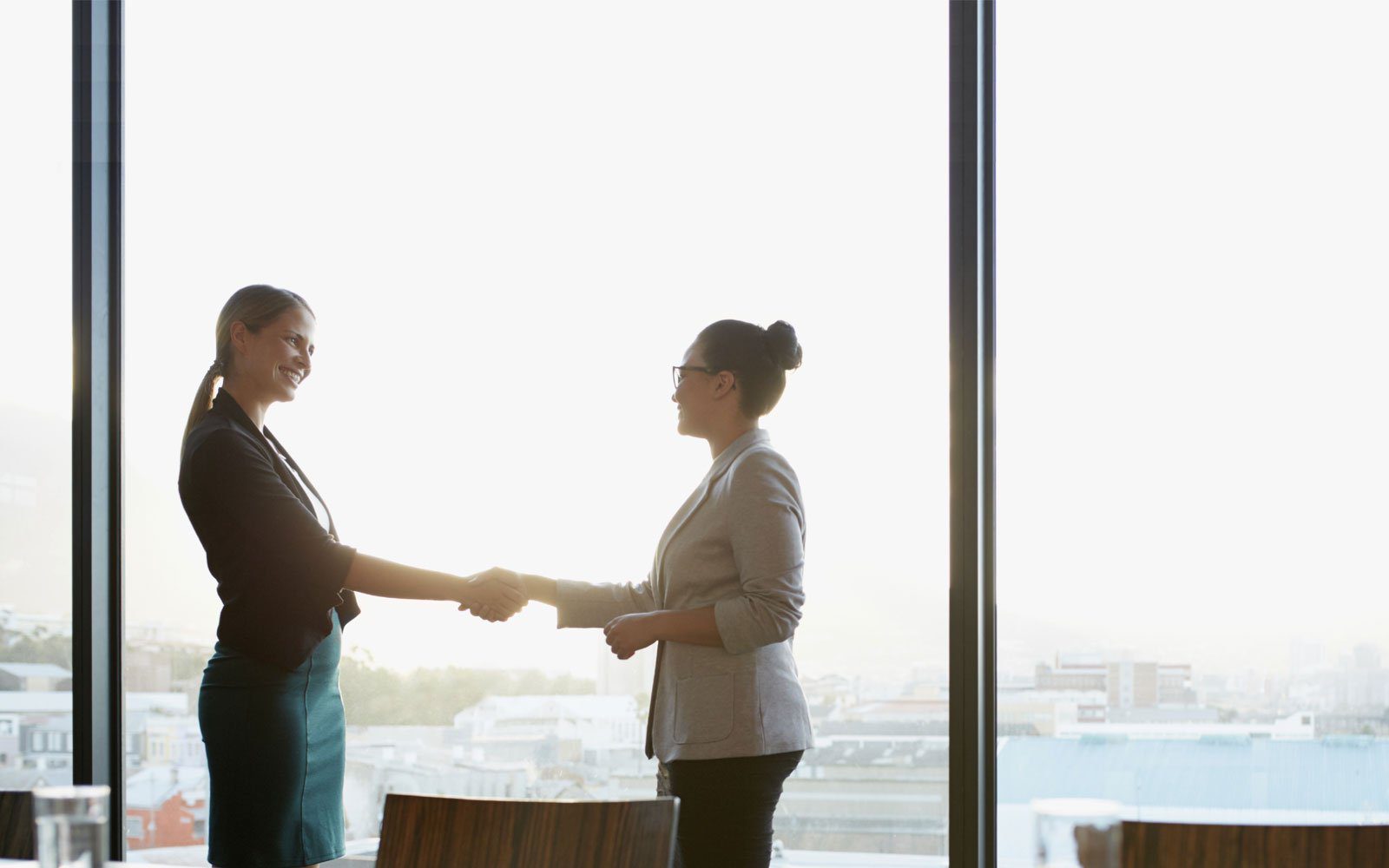 NEXTAFF recruitment agency franchise business women shaking hands.